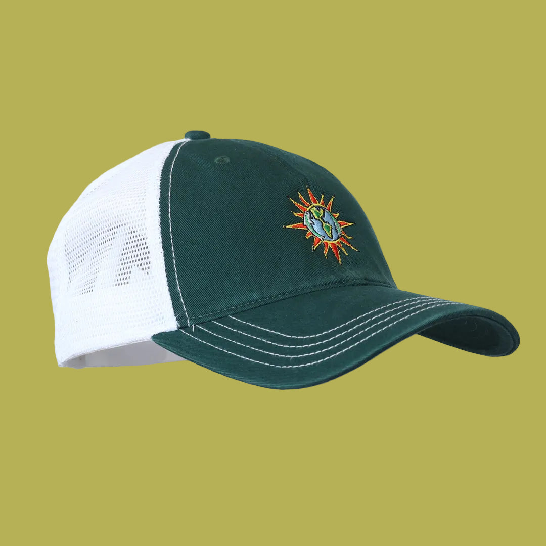 Green and white cap with a sun and moon design on a white background