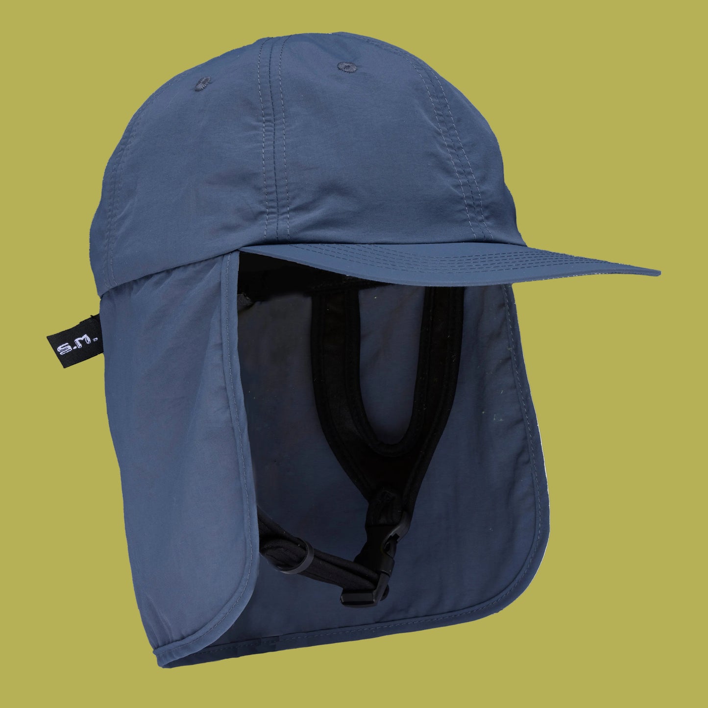blue surf hat with flap on green background