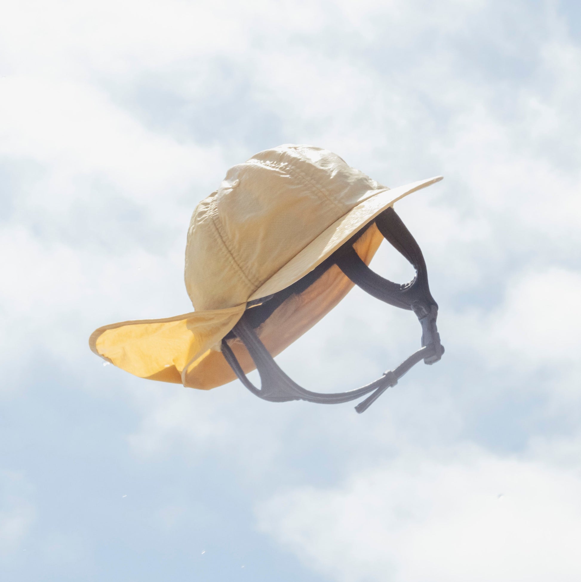 beige surf hat against blue sky