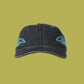 Black cap with blue embroidered designs on a white background
